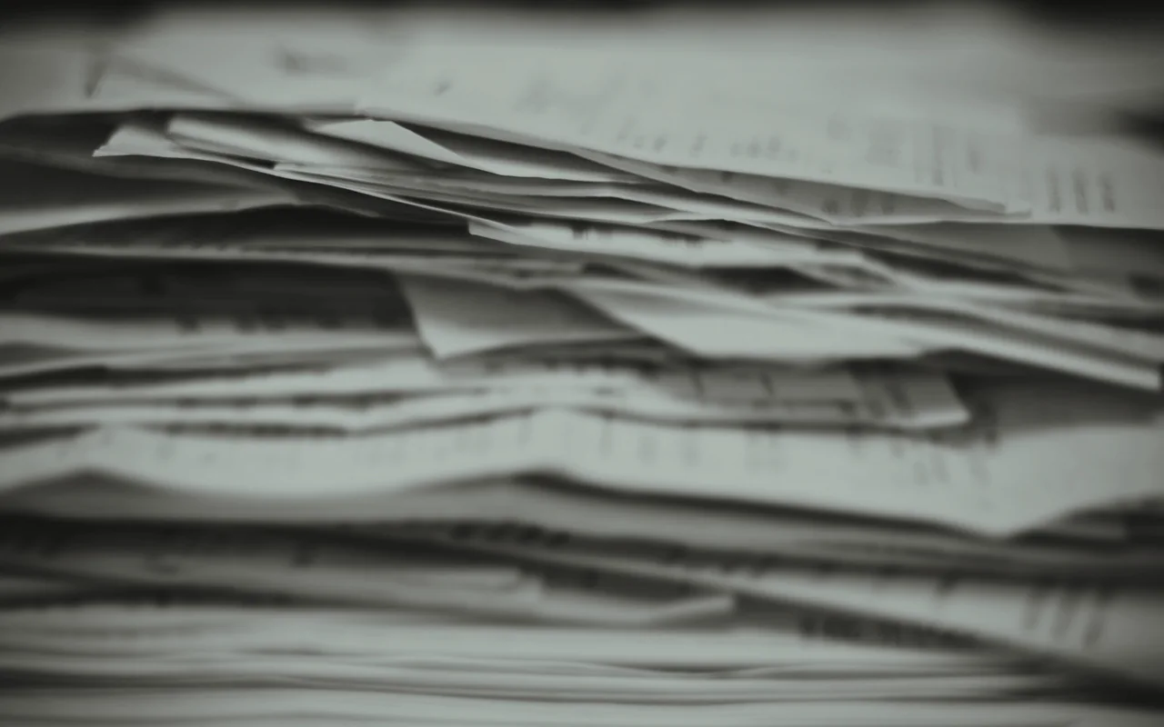 A tall stack of papers and receipts.